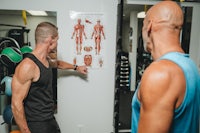 two men in a gym talking to each other